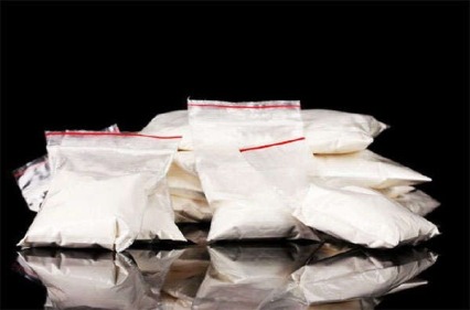 Photo of small baggies containing cocaine powder.