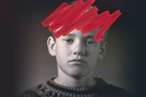 Boy with red marker drawn over his head