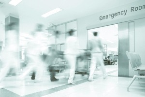 A blurred image of doctors rushing a patient through a hospital.